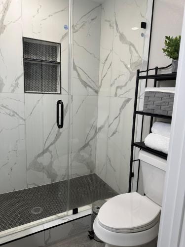 a bathroom with a shower with a toilet at Only minutes away from Surfside Beach in Freeport