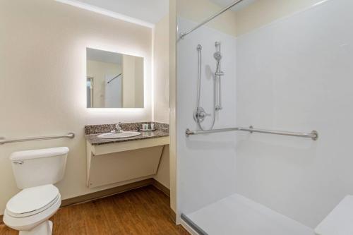a bathroom with a toilet and a sink and a shower at LeConte Hotel & Convention Center, an Ascend Collection Hotel in Pigeon Forge