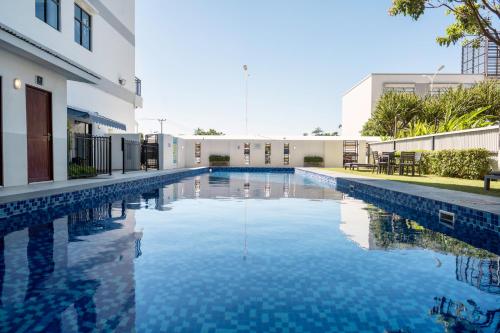 a swimming pool in front of a building at Timor Plaza Hotel & Apartments in Dili