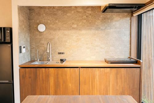 a kitchen with a sink and a counter at ceueu 櫟本駅 in Tenri