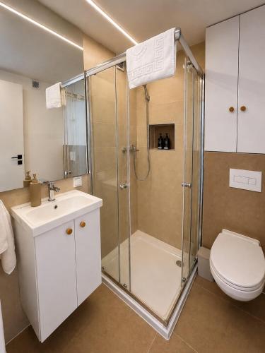 a bathroom with a shower and a toilet and a sink at Kupolica glamping dome in Brčko