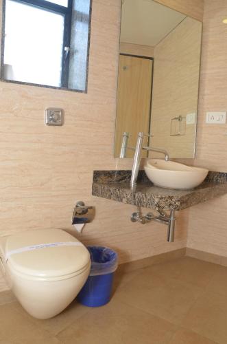 a bathroom with a toilet and a sink at HOTEL ASHRAY INTERNATIONAL, SION - Near BKC in Mumbai