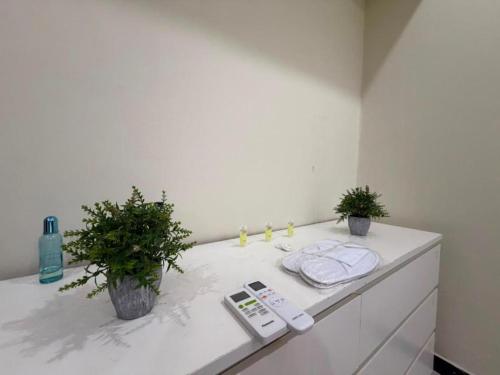 a bathroom counter with two plants on top of it at darnas in Jeddah