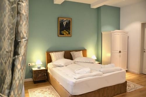 a bedroom with a large bed with white pillows at Sándor János Villa in Sovata