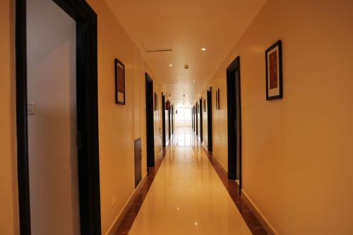 an empty corridor in a building with a long hallway at Hotel RAAGA INN in Tirupati