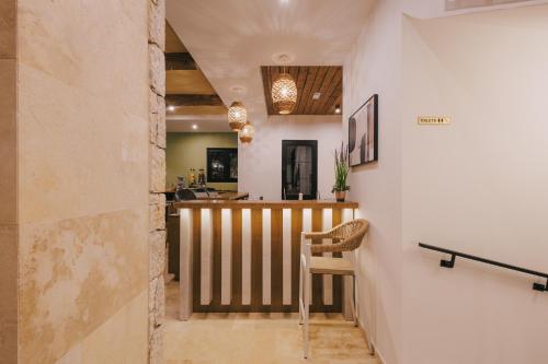 a room with a bar with a chair in it at Val D'or Olive Village in Ulcinj