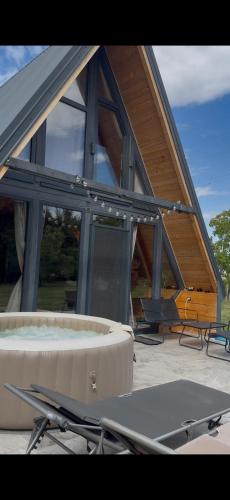 a house with a pool and a table and chairs at La Madera in Stanica Rumenka