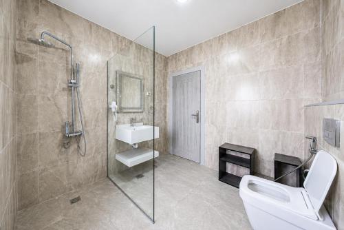 a bathroom with a shower and a toilet and a sink at B Suites Boutique Hotel in Amman