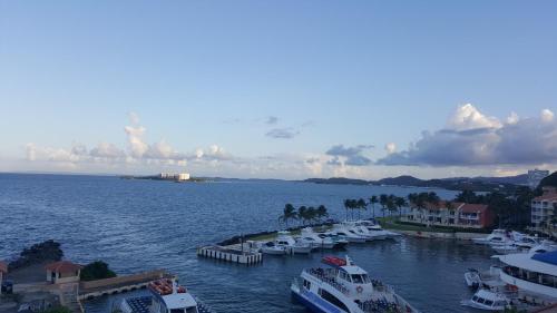 a group of boats docked in the water at Marina Lanais Condominio in Las Croabas