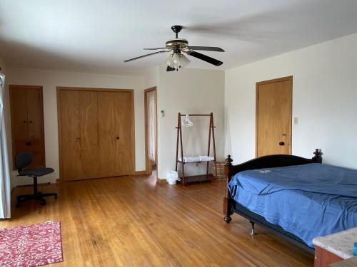 a bedroom with a bed and a ceiling fan at H on the bund in Saskatoon