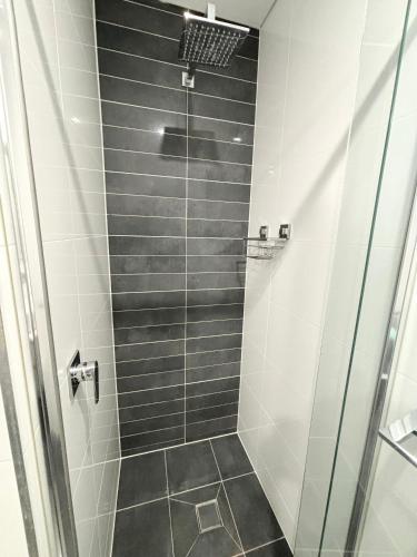 a bathroom with a shower with a glass door at Nineteen On Gregory G02 in South West Rocks