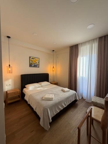 a bedroom with a large bed with two towels on it at La Montagna in Bangveti