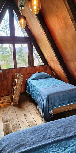a bedroom with a bed in a attic at Sp Atmatla Zacatlan Cabins in Zacatlán