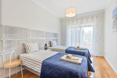 a hotel room with two beds and a window at Beach Sunset - Apartment Ocean in Vila Nova de Gaia