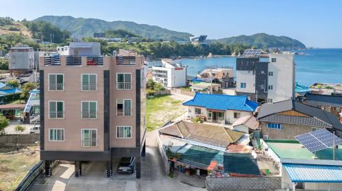 an aerial view of a city with buildings and the ocean at Samcheok Jisu Pension in Samcheok