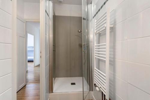 a bathroom with a shower with a glass door at Gîte la maison du sabotier in Saint-Malo-du-Bois