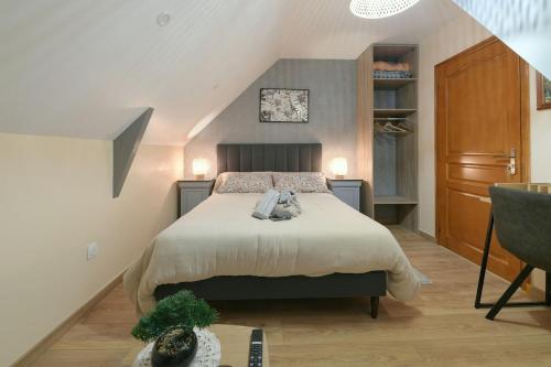 a bedroom with a large bed in a attic at Gîte du Pont d 'Amourette in Mayenne