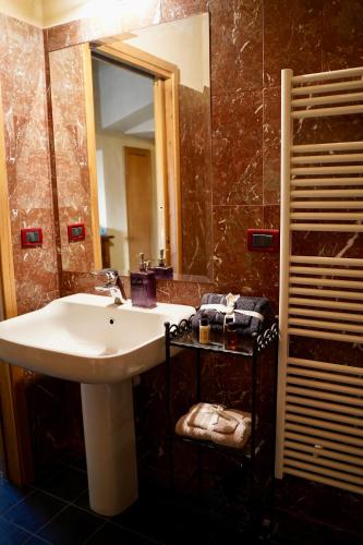 a bathroom with a sink and a mirror at Tenuta Bellassai in SantʼAlessio Siculo