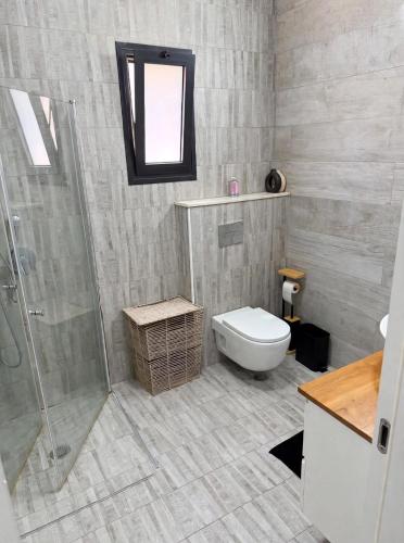 a bathroom with a toilet and a shower at וילת צאלים in Yeroẖam