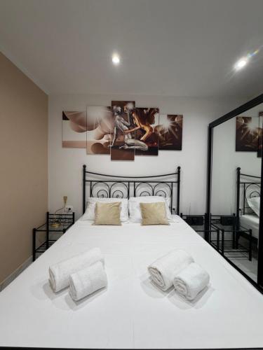 a bedroom with a large white bed with two pillows at La Dolce Vita in Piran