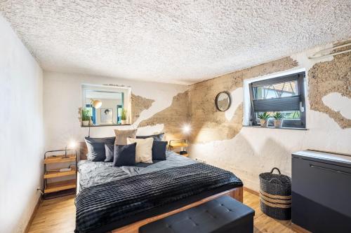 a bedroom with a king sized bed and a window at Fewo Abendruh in Elzach