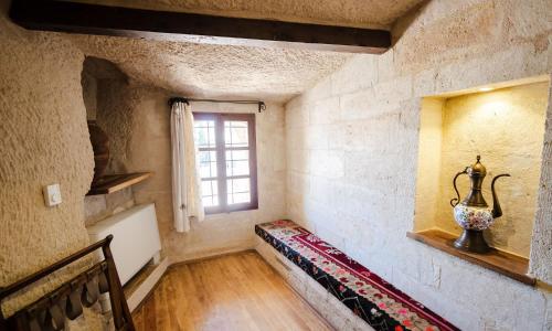 a room with a staircase with a window and a vase at Sultan Cave Suites in Göreme
