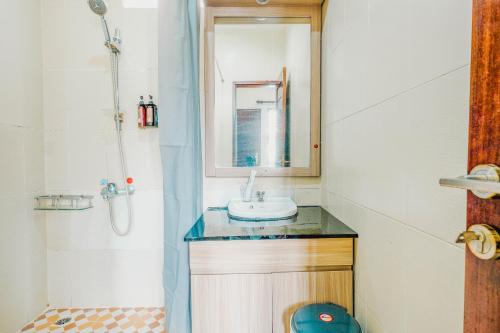 a small bathroom with a sink and a shower at Aleyra Hotel and Villa's Garut in Garut