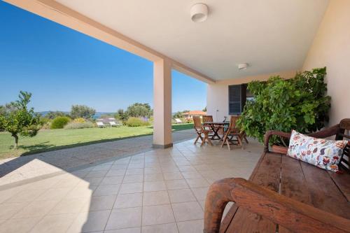 a patio with a bench and a table and chairs at Luxury Apartment Lake View in Bolsena