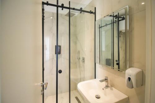 a bathroom with a shower and a sink at Velor Boutique Hotel in Tirana