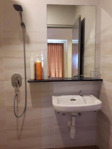 a bathroom with a sink and a mirror at De Benz Inn in Malacca