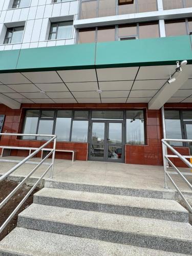 a building with stairs in front of a building at Amarida residence in Erdenet