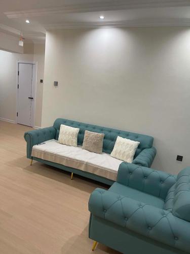 a blue couch sitting in a living room at Amarida residence in Erdenet