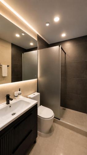 a bathroom with a toilet and a sink and a shower at Hotel Zerbulaq in Taraz