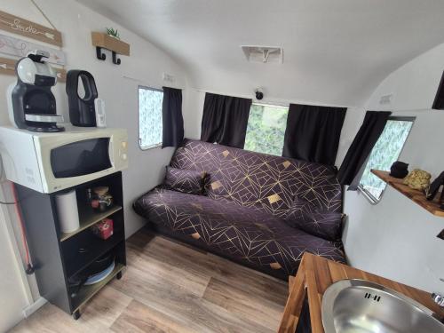 a small living room in a tiny house at Carabois in Esson