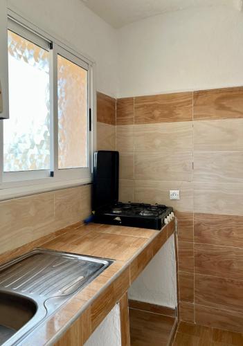 a small kitchen with a stove and a sink at Relax in Oued Laou in Oued Laou