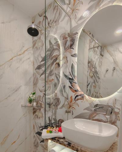 a bathroom with a sink and a mirror at Atlantiis Suites By Signature StayZ Girjaghar Near Vishwanath Temple in Varanasi