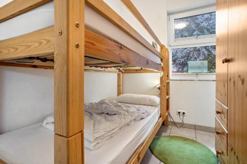 a bedroom with two bunk beds and a window at Haus 44 in Röbel
