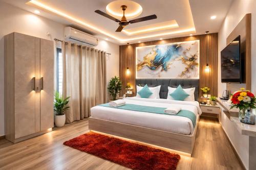 a bedroom with a large bed with a painting on the wall at Atlantiis Suites By Signature StayZ Girjaghar Near Vishwanath Temple in Varanasi