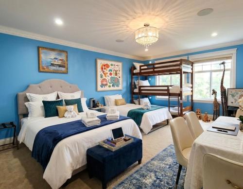 two beds in a room with blue walls at Royal Boutique Hotel, Greater Vancouver in Surrey