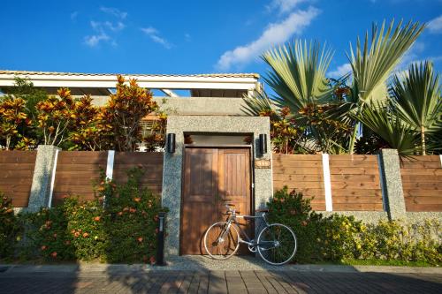 a bike parked in front of a wooden door at Papago International Resort in Chishang