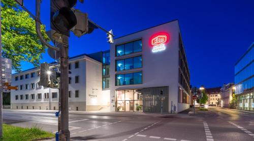 a building with a red sign on the side of it at Aiden by Best Western Biberach in Biberach an der Riß