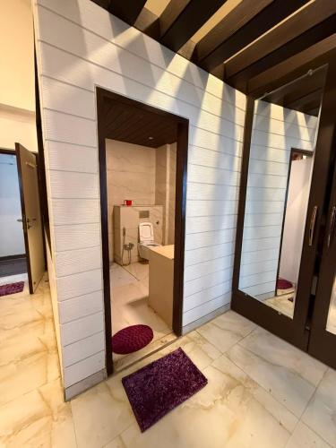 a bathroom with a mirror and a room with a sink at Chikku 4 bhk villa in Lonavala