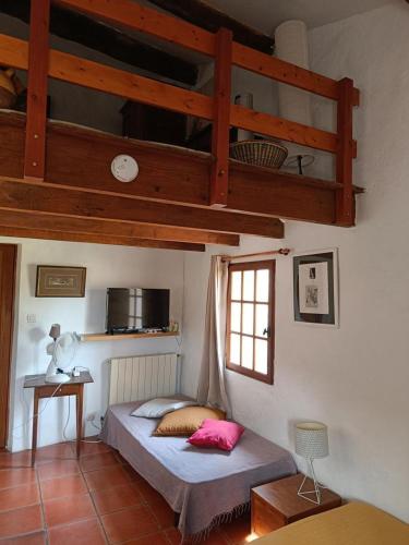 a bedroom with a bed and a loft at Le gîte panda saint-maymes in Trigance