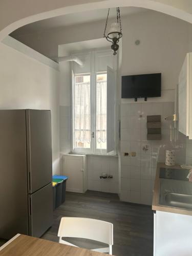 a kitchen with a refrigerator and a table at Casa mediterranea in Formia