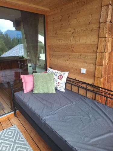 a couch with pillows sitting on a porch at Ferienwohnung Buchnerhof in Sankt Koloman