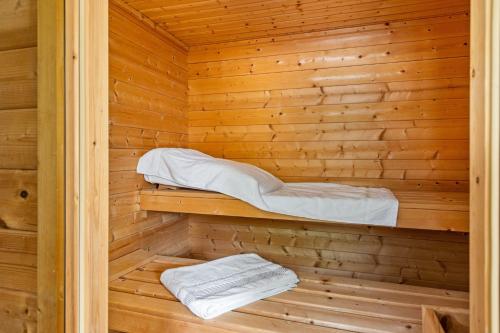 a sauna with wooden walls and white towels at Ferienwohnung Stoll in Brüel in Brüel