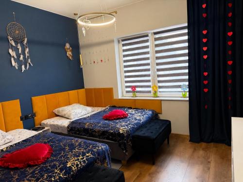 a room with two beds and a window at Golden Luxury Suite in Nowy Dwór Mazowiecki