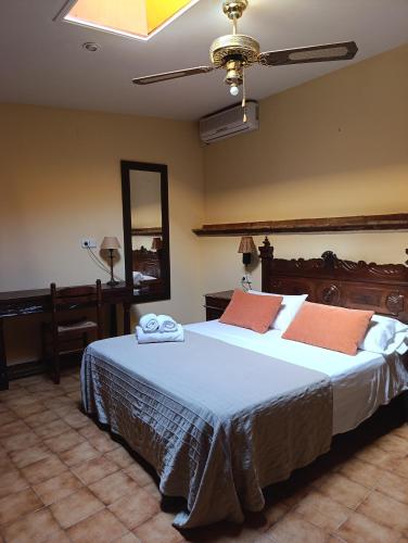 a bedroom with a large bed with towels on it at Mas Duran in La Pera