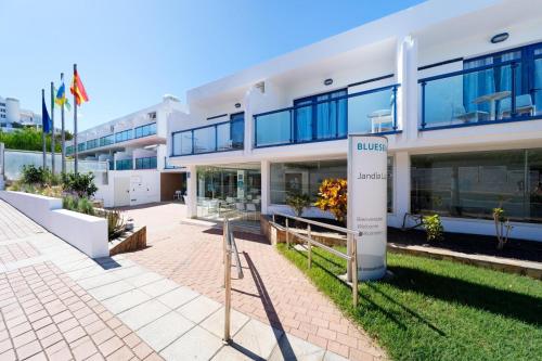 a large white building with blue windows at BLUESEA Jandia Luz in Morro del Jable