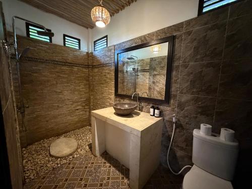 a bathroom with a sink and a toilet at Dream Makers Retreat in Gili Islands